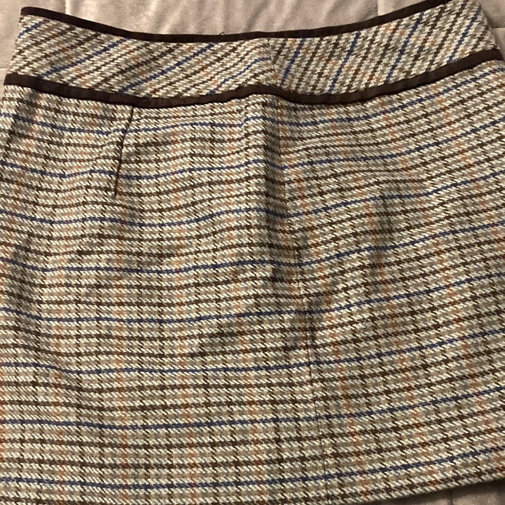 plaid skirt with leather trim.